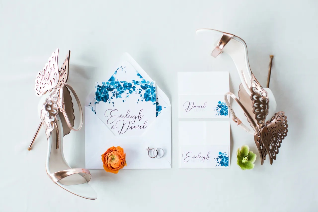 Stationery suite detail, styled with the bride's shoes and rings.